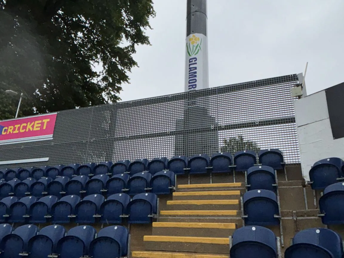 To summarise the cricket stand had some existing steel work that held some plywood sheeting to which the advertising boards where attached.

The existing became a little tired and needed to be replaced, they replaced the existing with new steelwork based on a stronger design that could support the GRP panels which we supplied.

The GRP panels now support the signage and as the GRP is an open structure the wind loading was reduced as part of the design.

